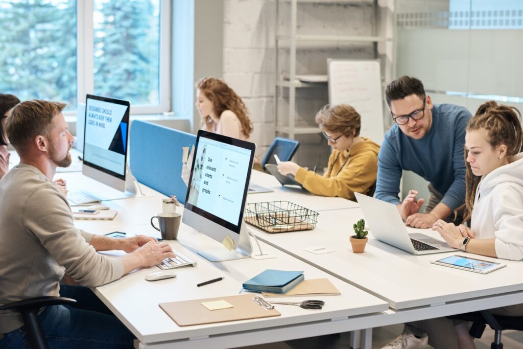 Employees in an open plan office, working on computers