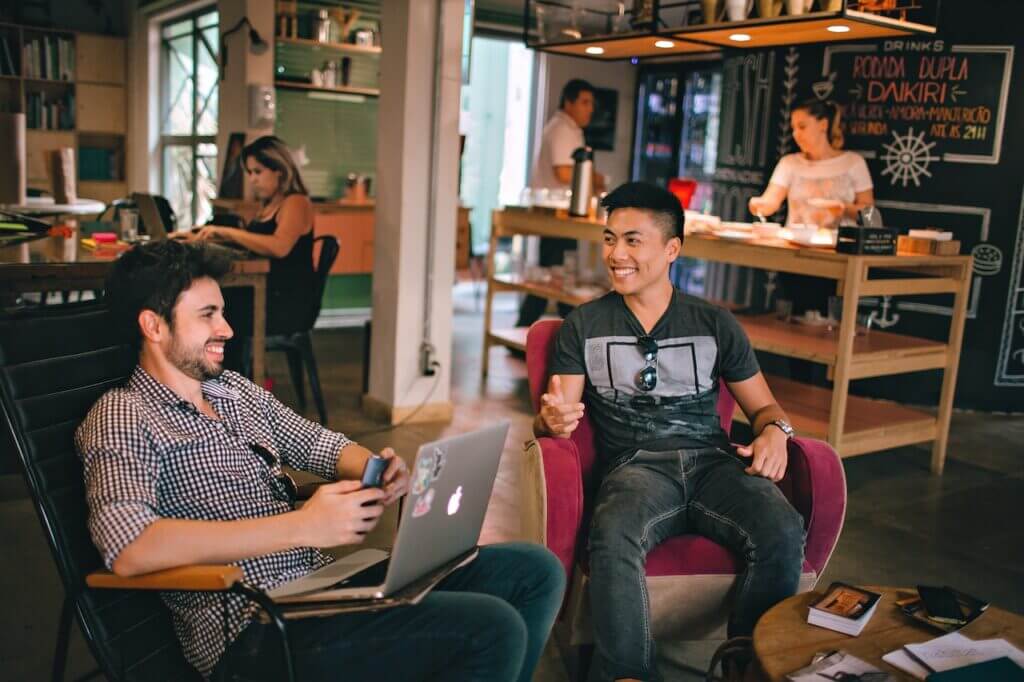 Two males laughing at a co-working space 
