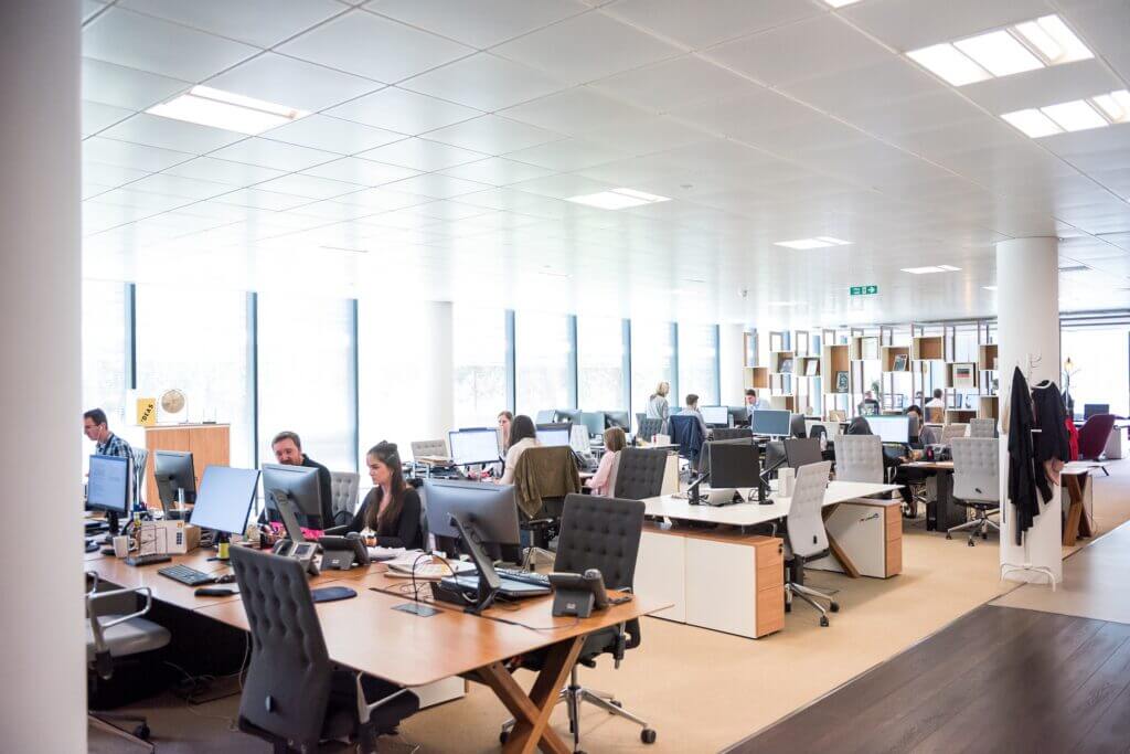 People working on computers in an open plan office setting