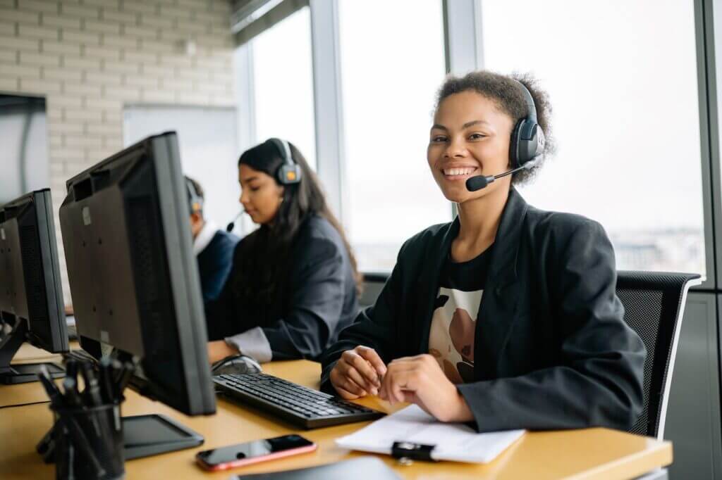 Contact center agent smiling on her working desk