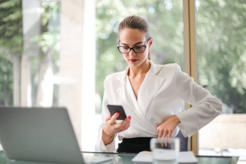 Women looking into phone in an office setting