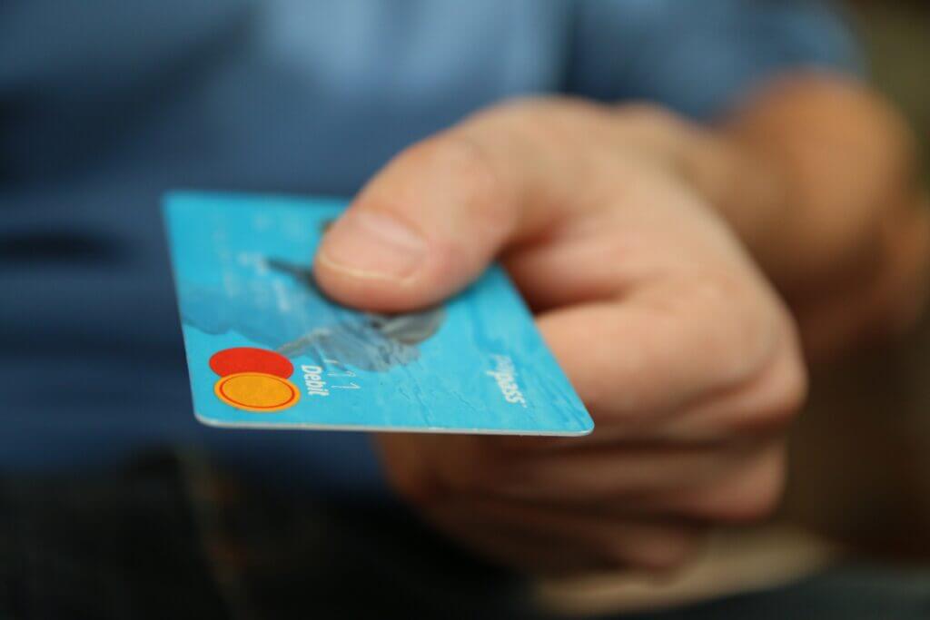 A hand holding a credit card