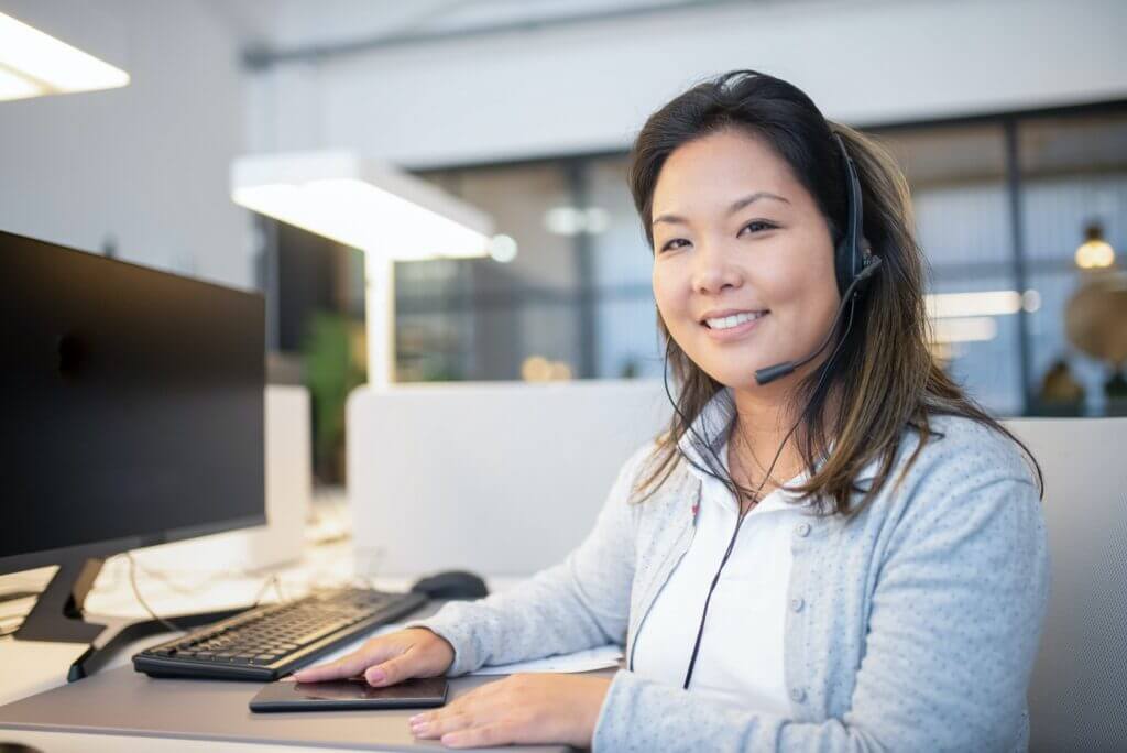 Warm and attentive call center rep wearing a headset.