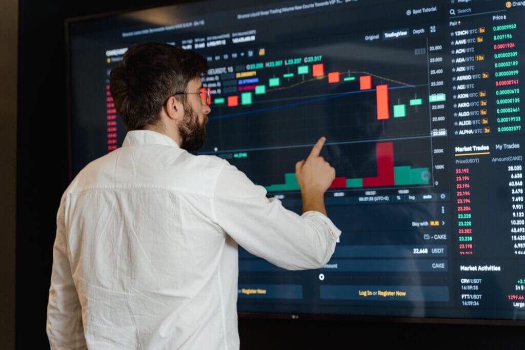 Workforce Management Expert analyzing graphical data on a big monitor.