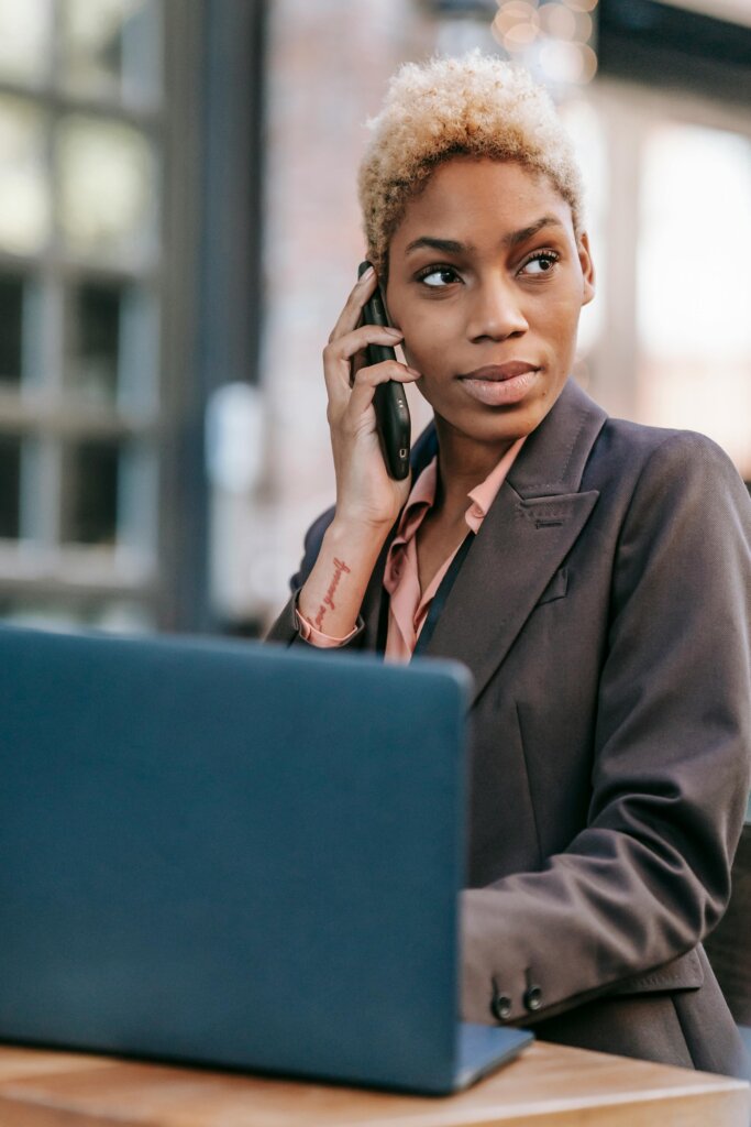 A smart-looking, attractive woman talking on a mobile phone.