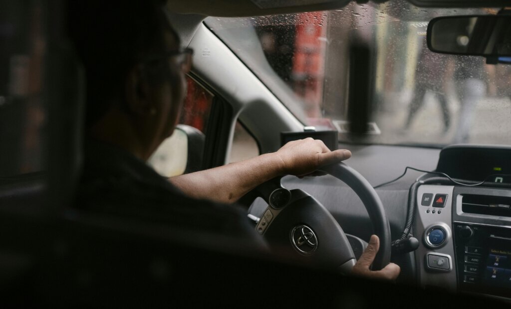 Driver siting in car in rainy weather
