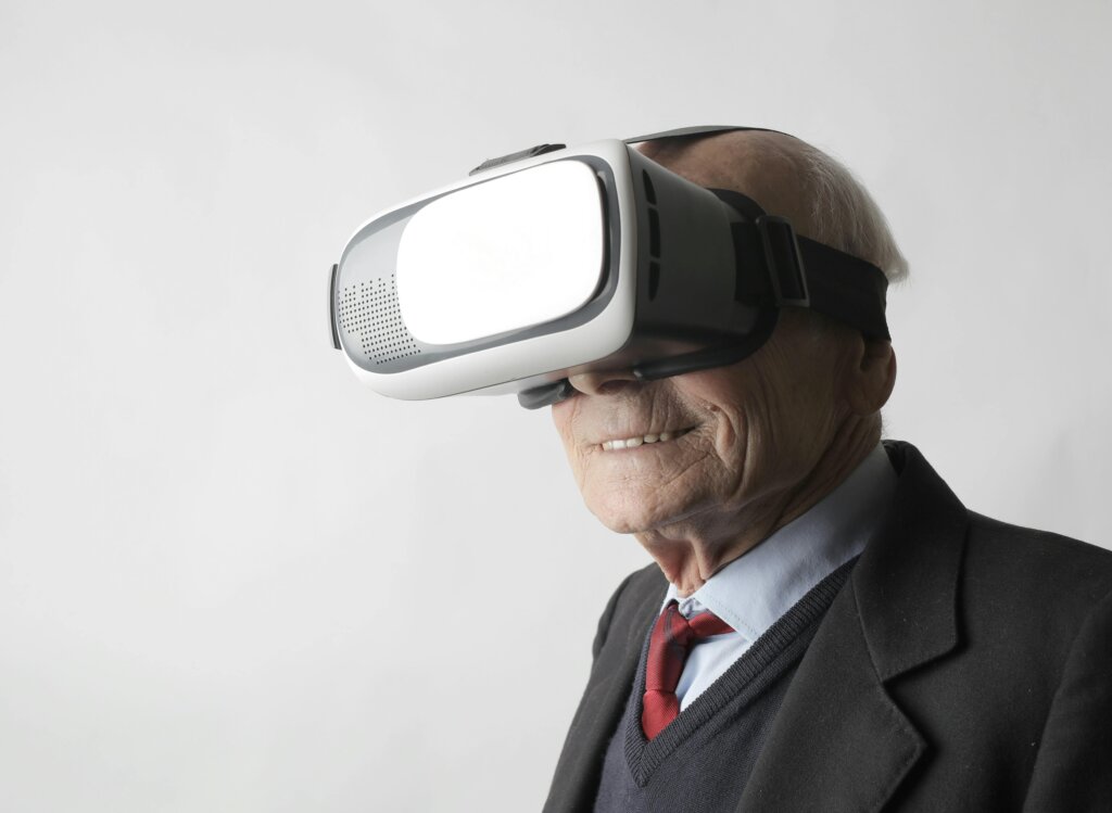 Senior man using VR goggles in studio
