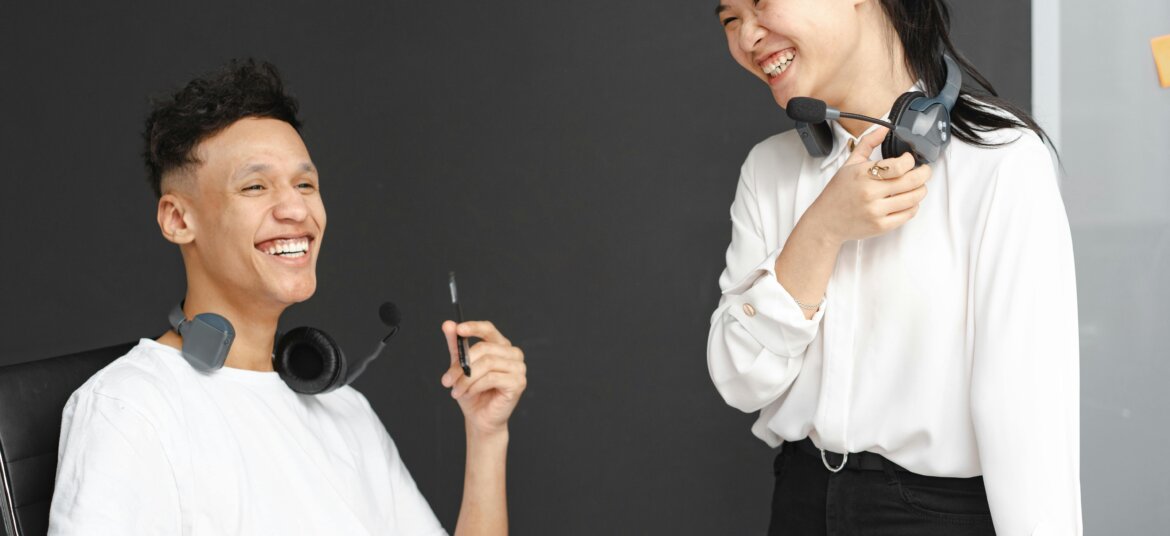 Laughing Man and Woman Working in a Call Center