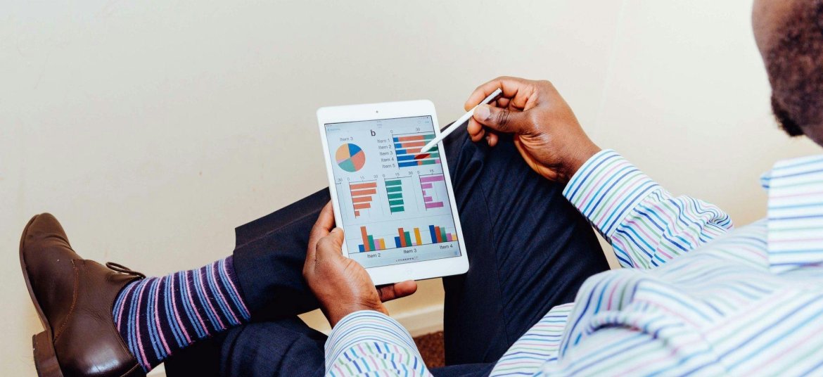 Man Wearing White and Blue Pinstriped Dress Shirt Holding White Ipad