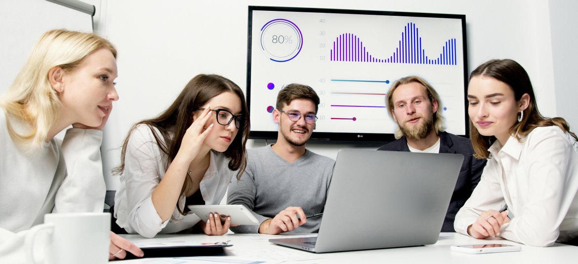 A diverse group of young professionals collaborating in a modern office environment.