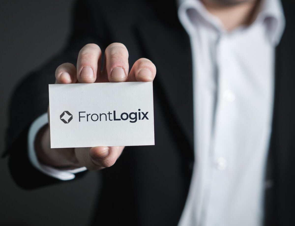 Man holding a FrontLogix business card